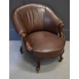 A 20th century brown leather antique style mahogany tub chair.