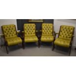 A set of four 20th century mahogany and green leather clad button back arm chairs.