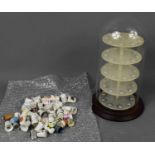 A glass domed thimble display case together with a group of thimbles to include enamel and silver