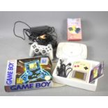 A vintage Nintendo Game Boy with the original box and Playstation One.
