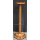 A Robert 'Mouseman' Thompson of Kilburn, an english oak octagonal column and base / candle /