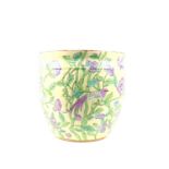 An oriental style pottery jardiniere depicting a floral scene with birds and flowers on the