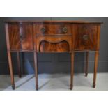 A reproduction mahogany serpentine sideboard, with two cupboard doors, raised on square tapered