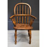 A 19th century Child's Windsor armchair, with bowed top rail, spindle back and crinoline stretcher.