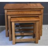 Robert 'Mouseman' Thompson oak nest of three tables, adzed rectangular tops, on four octagonal legs,