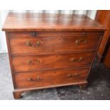 A 19th century mahogany bachelors chest with three long graduated drawers raised on bracket feet,