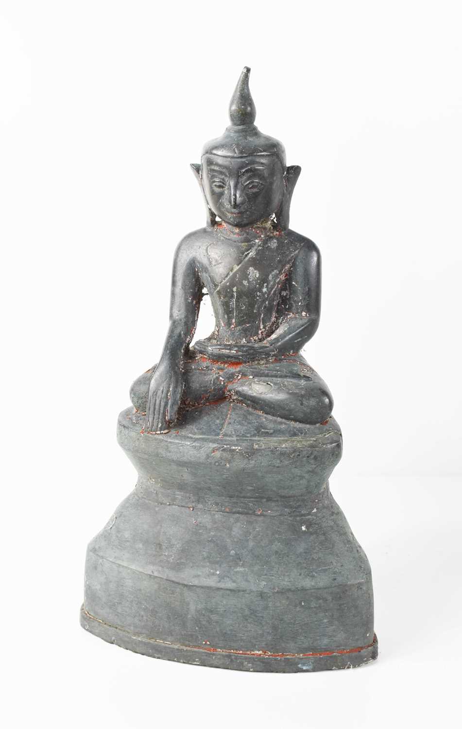 A bronze statue of the Buddha in Bhumisparsha Mudra pose, with serene face, sat cross legged on a