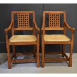 A pair of oak Rabbitman Peter Heap carver armchairs, the lattice backs above leather seats, carved