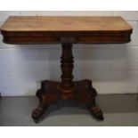 A 19th century rosewood tea table with folding top, carved flower head paterae and beaded border