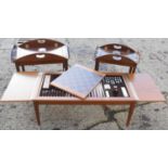 A vintage teak effect games table for chess and backgammon together with two butlers trays on