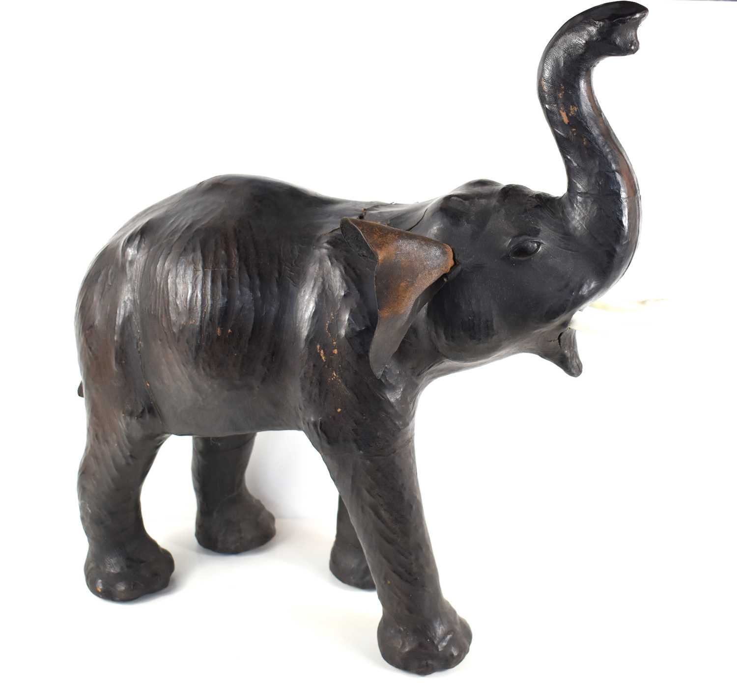 An early twentieth century Liberty of London leather elephant, inset with glass eyes, plastic/