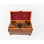 A 19th century burr yew sarcophagus tea caddy with boxwood stringing, complete with hinged lidded