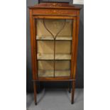 An Edwardian mahogany display cabinet with astragal glazed door, enclosing two shelves and painted