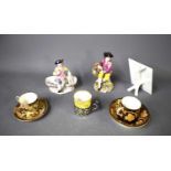A group of porcelain figures and cups and saucers, to include Royal Worcester and Wedgwood, and a