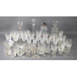 A group of crystal glass decanters and various drinking glasses to include examples by Stuart,