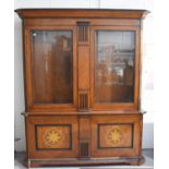 A large hardwood display cabinet, the upper section having two large bevelled glass panelled doors