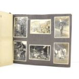 A vintage photo album titled 'West African Views' and dated 1943, containing approximately 65 photos