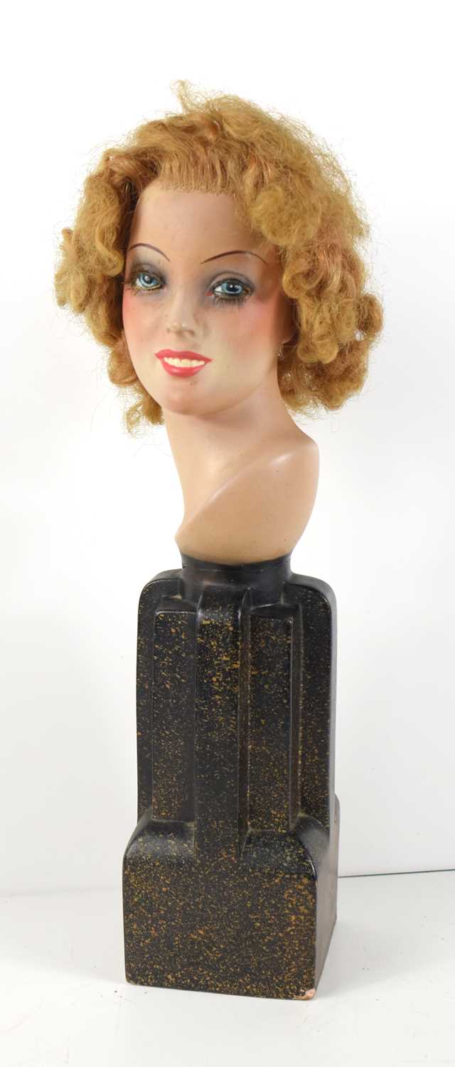 An Art Deco style terracotta bust of a women raised on a shaped base, 36cm high.