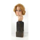 An Art Deco style terracotta bust of a women raised on a shaped base, 36cm high.