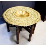 A large antique Middle Eastern brass top table, the multi foil recessed centre bordered by