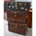 Three vintage travelling trunks to include a green canvas example bearing travel labels together