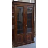 A French style burr veneered cabinet with two glazed panel doors enclosing three height adjustable