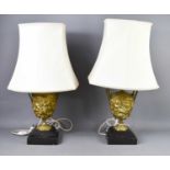 A pair of 19th century gilt metal table lamps, of urn form, modelled in relief to depict classical