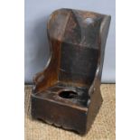 A 19th century boarded oak child's commode chair.