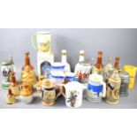 A group of Bells whisky decanters together with various tankards and jugs to include Portmeirion,