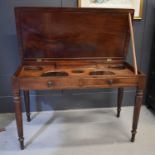 A 19th century mahogany twin wash stand, the lid opens to reveal a top cut with wash bowl holders,
