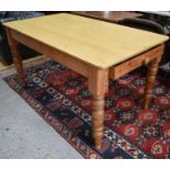 A pine kitchen table with two drawers, turned legs, with a yellow painted / varnish top, 80cm high