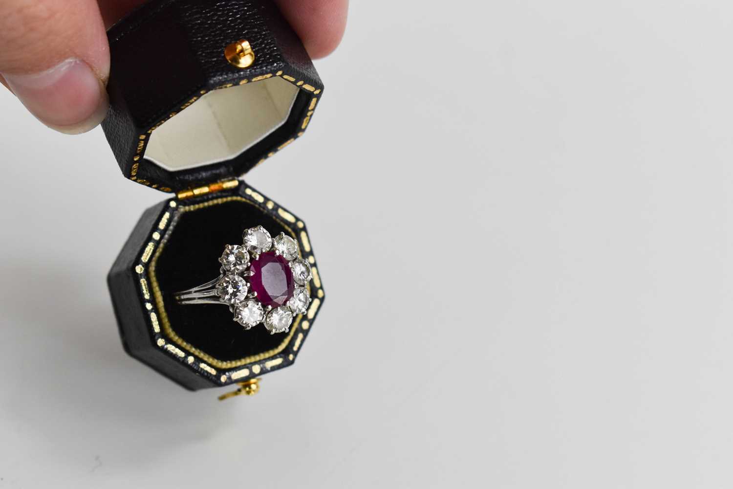 An 18ct white gold, (unmarked but tested as 18ct) ruby and diamond flowerhead ring, the central oval - Image 10 of 11