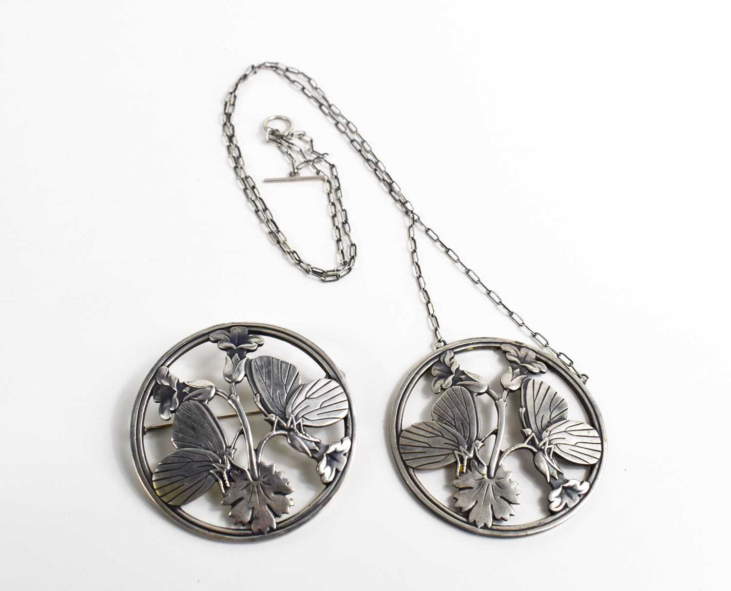 A Georg Jensen silver pendant necklace and matching brooch, both of circular form pierced to - Image 4 of 4