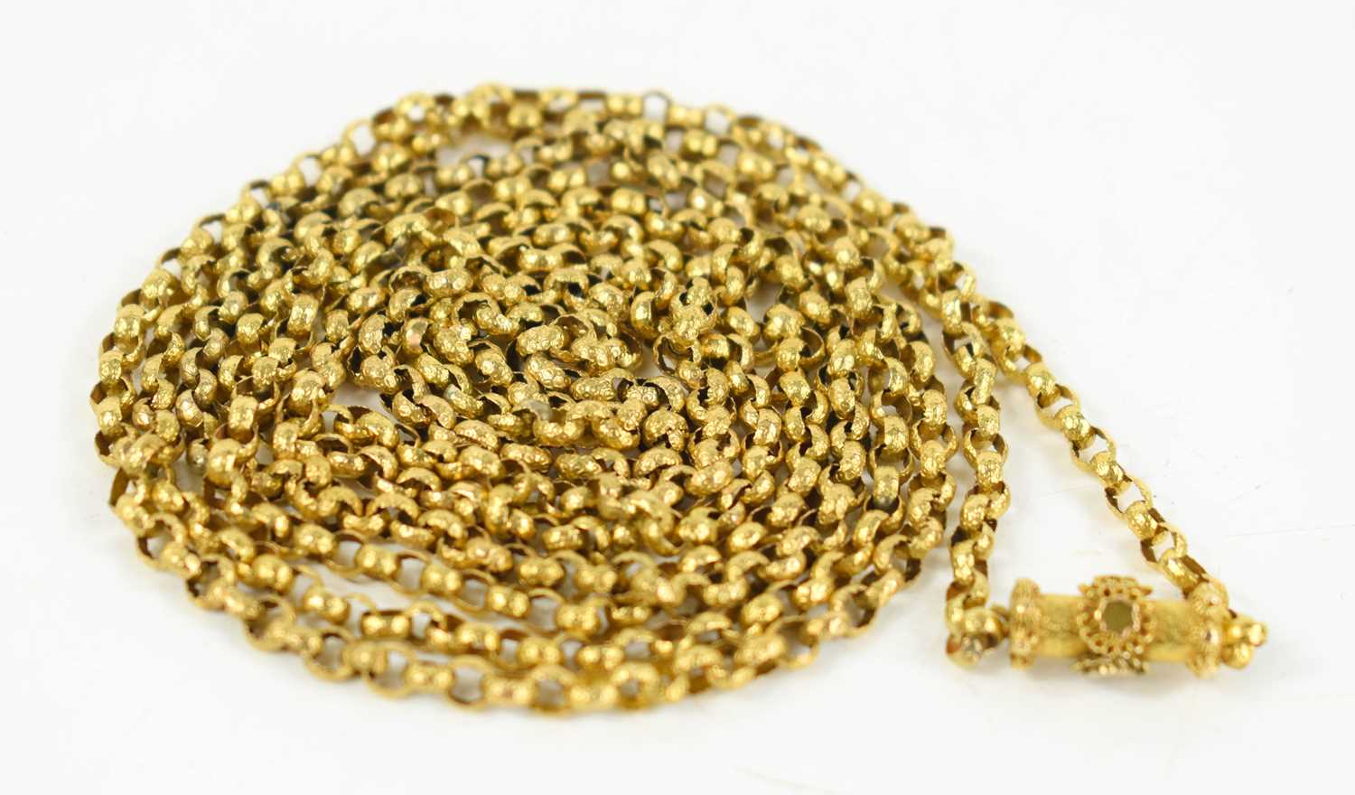 A Georgian long gold box link guard chain, each of the circular links with engraved decoration and