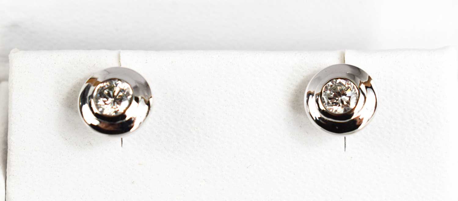 A pair of 18ct white and diamond stud earrings, 0.50ct total weight.