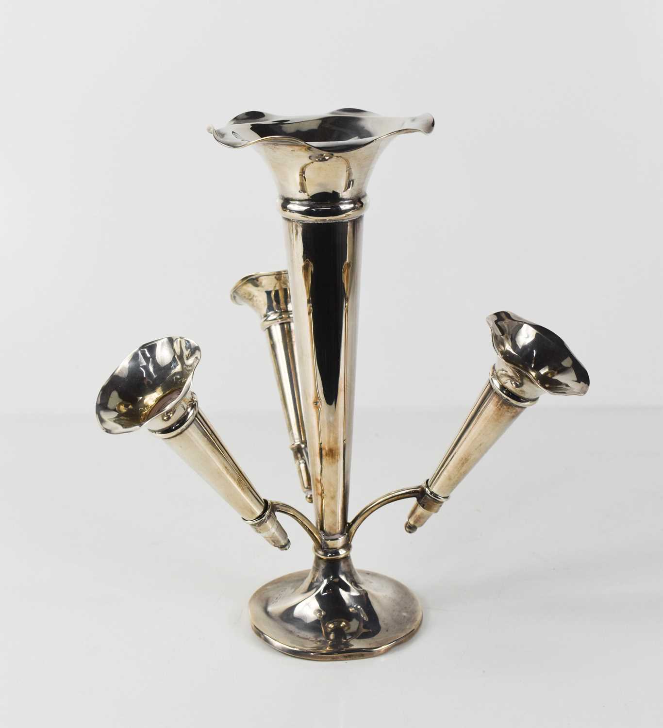 A silver epergne, with central flared trumpet vase, with fluted rim, surounded by three smaller