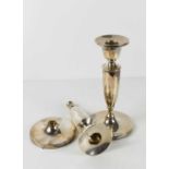 A pair of silver candlesticks of simple baluster form, with circular weighted bases, one a/f base