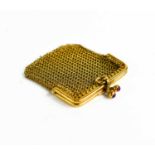 A 9ct gold mesh coin purse with ruby cabochon to the clasp, 16.5g.