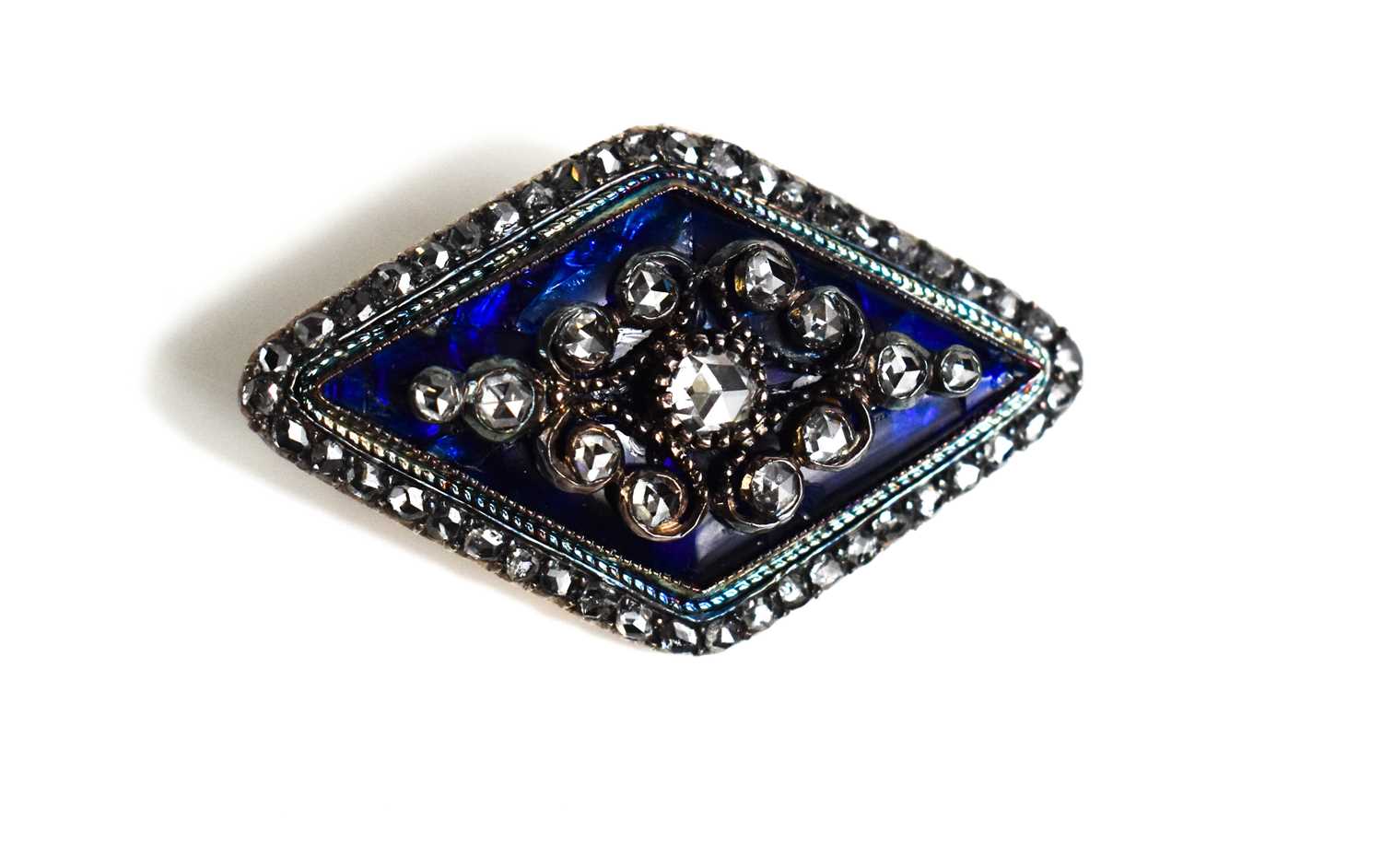 A 19th century diamond and enamel brooch, of diamond form, the old cut diamonds set in scrollwork on