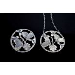 A Georg Jensen silver pendant necklace and matching brooch, both of circular form pierced to