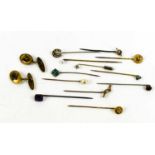 A group of twelve stick stock pins including two 15ct gold Victorian examples, one set with a seed