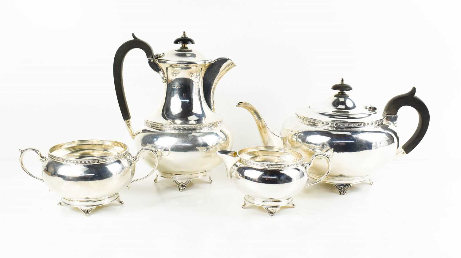 A silver tea service comprising tea pot, hot water pot, milk jug and sugar bowl, Sheffield 1936,