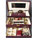 A jewellery box containing costume jewellery to include rings, charms, bracelets, Scottish grouse