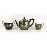 An Art Deco, Grish Chunder Dutt, Indian silver tea set, with gadroon decoration, comprising tea