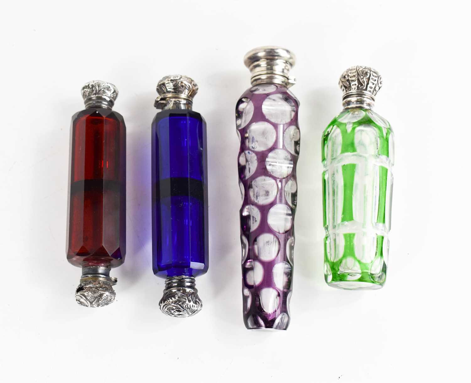 Four Victorian glass scent bottles, including a cut glass example with amethyst coloured overlay,