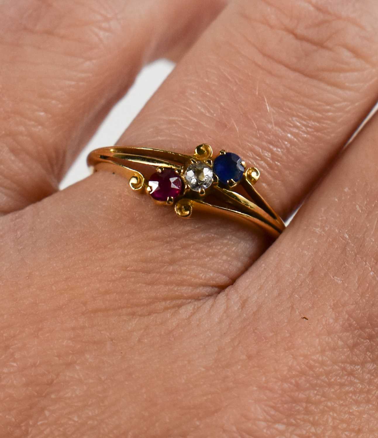 An 18ct gold, diamond, ruby and sapphire ring, the three stones in crossover scroll setting, size M, - Image 2 of 2