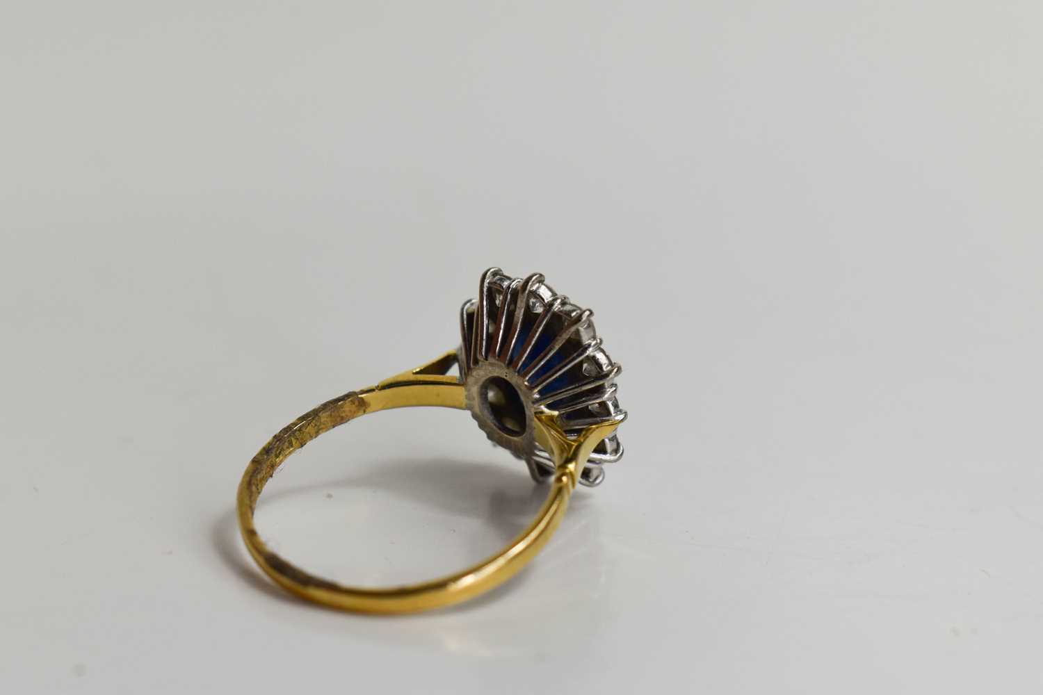 An 18ct gold, sapphire and diamond, flowerhead ring, the oval cut deep cornflower blue stone of - Image 4 of 6