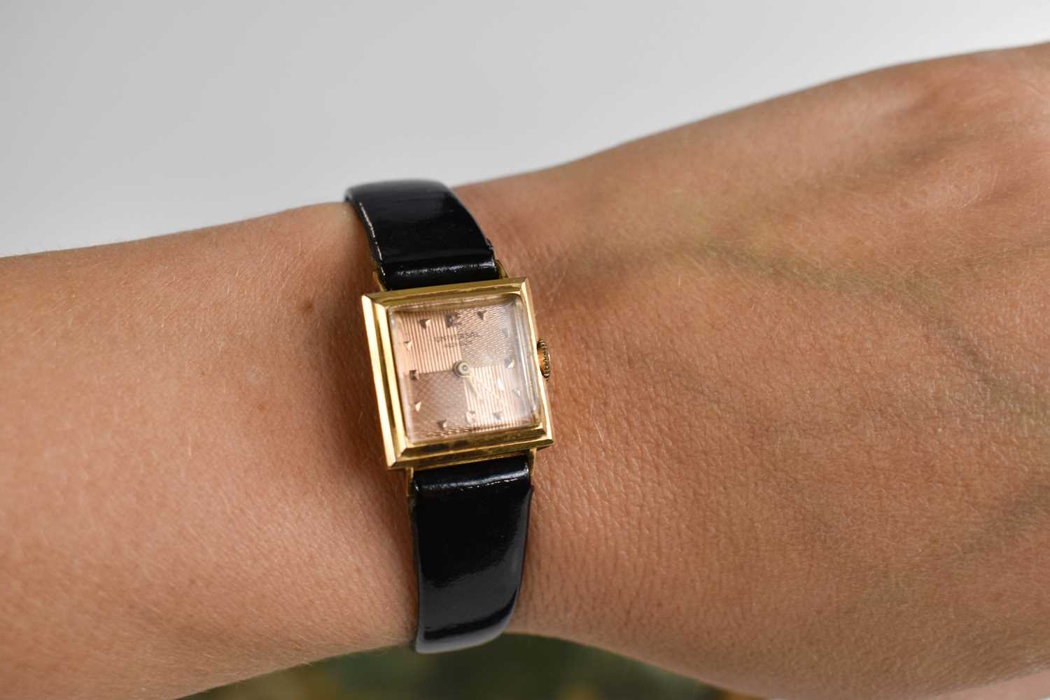 An 18ct Universal gold cased lady's watch, with engine turned rose gold coloured dial, with black - Image 4 of 4