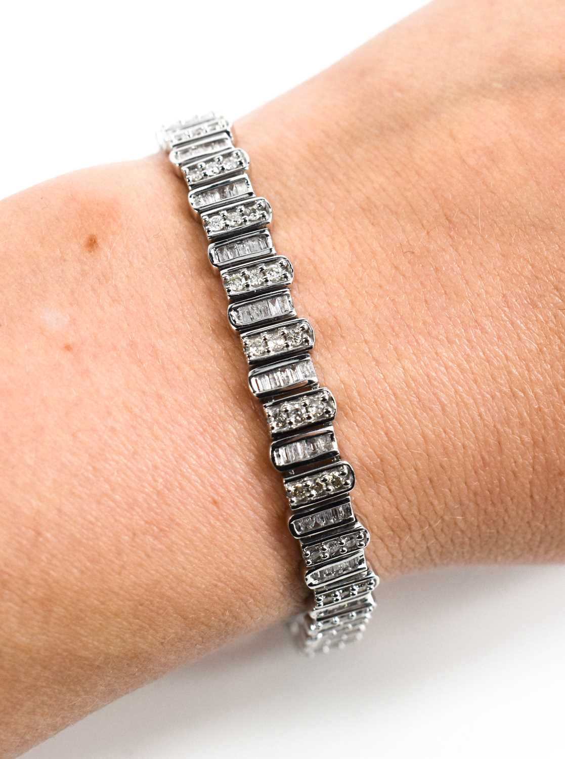 A 9ct white gold and diamond tennis bracelet, composed of links set with baguette cut and - Image 3 of 6