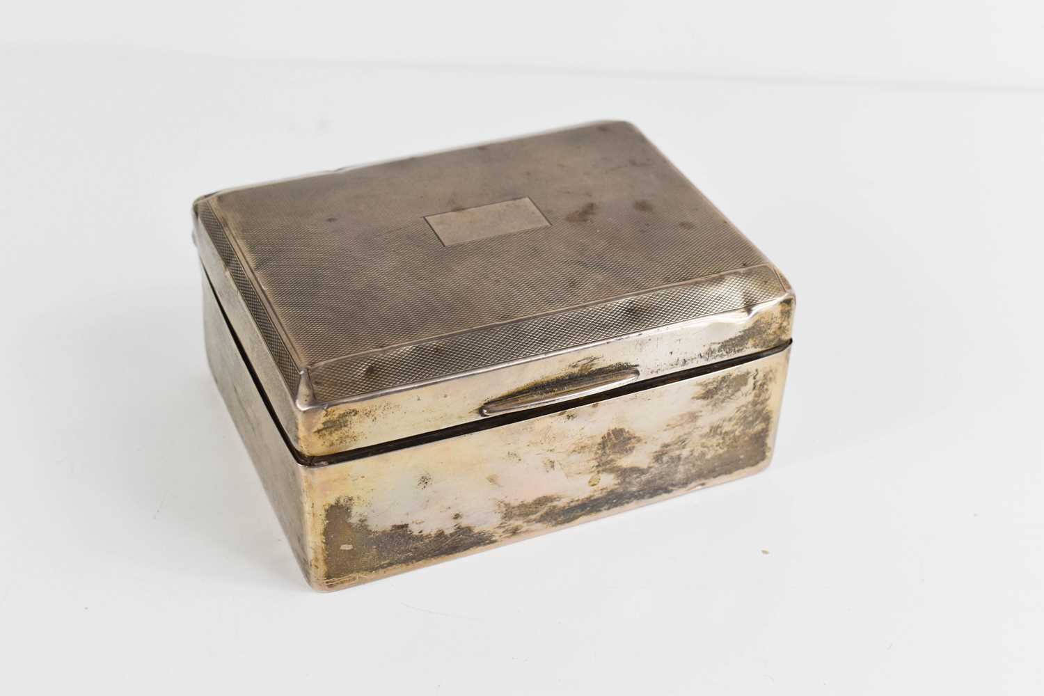 A silver cigarette box, with engine turned decoration, William Neale & Son Ltd, Birmingham 1931,